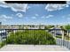 Serene balcony view showcasing lush greenery, a city street and a bright, blue sky at 425 S Parkcrest -- # 335, Mesa, AZ 85206