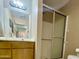 Bathroom featuring a glass-enclosed shower, vanity with sink, and ample lighting at 425 S Parkcrest -- # 335, Mesa, AZ 85206