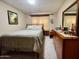 Cozy bedroom with a comfortable bed, a dresser with a mirror, and natural light from the windows at 425 S Parkcrest -- # 335, Mesa, AZ 85206
