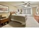Cozy bedroom featuring a ceiling fan, window with curtains, and comfortable bedding at 425 S Parkcrest -- # 335, Mesa, AZ 85206