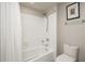 Cozy bathroom with a shower-tub combo, white tiled walls, and modern fixtures at 4303 E Cactus S Rd # 229, Phoenix, AZ 85032