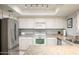 Bright kitchen featuring white cabinets and stainless steel appliances at 4303 E Cactus S Rd # 229, Phoenix, AZ 85032
