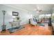 Spacious living room with hard wood floors, sofa, and view of the balcony at 4303 E Cactus S Rd # 229, Phoenix, AZ 85032