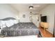 Cozy main bedroom with comfortable bed, side table, and adjacent bathroom at 4303 E Cactus S Rd # 229, Phoenix, AZ 85032