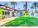 Beautiful backyard with lush landscaping, covered patio, and open green space at 4420 N 47Th Pl, Phoenix, AZ 85018
