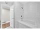 Stylish bathroom featuring a built-in tub with a gold shower head and white subway tile at 4420 N 47Th Pl, Phoenix, AZ 85018