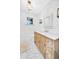 Bright bathroom featuring a wooden vanity with marble countertop and classic white subway tile at 4420 N 47Th Pl, Phoenix, AZ 85018