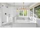 Bright bathroom featuring a standalone tub, and a glass-enclosed shower with detailed tile work at 4420 N 47Th Pl, Phoenix, AZ 85018