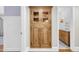 Hallway featuring a built-in hutch with decorative wood and views of the bathroom at 4420 N 47Th Pl, Phoenix, AZ 85018