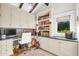 Well-lit home office with custom built-ins, desk space, and hardwood floors at 4420 N 47Th Pl, Phoenix, AZ 85018