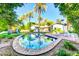 Resort-style backyard with a sparkling pool, lush landscaping, and palm trees at 4420 N 47Th Pl, Phoenix, AZ 85018