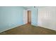 Blue bedroom with plush carpet, a large closet, and doorway leading to another room at 5 W Ranch Rd, Tempe, AZ 85284