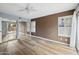 Bedroom featuring hardwood floors, large windows, and mirrored closet with ample storage space at 5 W Ranch Rd, Tempe, AZ 85284