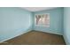 Cozy bedroom with plush carpet, bright blue walls, and plantation shutters offering plenty of natural light at 5 W Ranch Rd, Tempe, AZ 85284