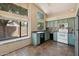 Quaint kitchen featuring ceramic tile flooring, neutral appliances, lots of windows, and muted blue cabinetry at 5 W Ranch Rd, Tempe, AZ 85284