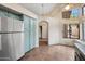 Open kitchen layout with stainless steel refrigerator and adjacent breakfast nook featuring terra cotta tile floor at 5 W Ranch Rd, Tempe, AZ 85284