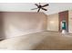 Bright and airy living room featuring neutral carpet, decorative lighting, and an arched doorway at 5 W Ranch Rd, Tempe, AZ 85284