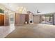Large living area featuring neutral carpeting, decorative lighting, and a sliding glass door to a fenced in outdoor space at 5 W Ranch Rd, Tempe, AZ 85284