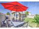 Spacious backyard with patio furniture and umbrella, perfect for outdoor entertaining and relaxation at 515 S Apache Dr, Chandler, AZ 85224