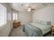 Bedroom with gray carpet, light walls, neutral bedding, and a window with plantation shutters at 515 S Apache Dr, Chandler, AZ 85224