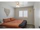 Cozy bedroom featuring gray carpet, neutral walls, sliding closet doors, and window with plantation shutters at 515 S Apache Dr, Chandler, AZ 85224