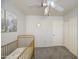 Bedroom with white walls, carpet floors, a gold crib, white trim, and a closet with sliding doors at 515 S Apache Dr, Chandler, AZ 85224