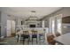 Bright dining area features wood floors, a modern light fixture, and seating for six at 515 S Apache Dr, Chandler, AZ 85224