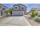 Two-story home featuring neutral stucco, a two-car garage, and a well-maintained desert landscape at 515 S Apache Dr, Chandler, AZ 85224