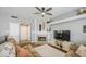 Comfortable living space with a decorative fireplace, ceiling fan, and adjacent barn door at 515 S Apache Dr, Chandler, AZ 85224