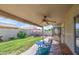 Covered patio with ceiling fan and stamped concrete, leading to a well-maintained backyard with lush green grass at 515 S Apache Dr, Chandler, AZ 85224