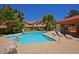 Inviting community pool with lounge chairs, lush landscaping, and clear blue water at 5808 E Brown Rd # 60, Mesa, AZ 85205