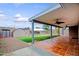 Covered back patio with ceiling fans, tile flooring, and views of the backyard and storage shed at 6120 W Keim Dr, Glendale, AZ 85301