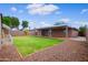 Expansive backyard featuring a covered patio, lush lawn, and gravel landscaping, perfect for outdoor living at 6120 W Keim Dr, Glendale, AZ 85301