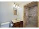 Beautifully renovated bathroom featuring a tiled shower with modern fixtures and a granite vanity at 6120 W Keim Dr, Glendale, AZ 85301