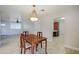 Charming dining area with a classic wooden table and chandelier, seamlessly connecting the kitchen and living spaces at 6120 W Keim Dr, Glendale, AZ 85301