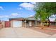 Charming single-story home featuring a well-maintained lawn, a covered front porch, and a driveway at 6120 W Keim Dr, Glendale, AZ 85301