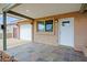 Covered front porch on exterior with tile flooring and a view of the garage at 6120 W Keim Dr, Glendale, AZ 85301
