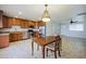 Well-appointed kitchen featuring stainless steel appliances, wooden cabinets, and a dining area with a chandelier at 6120 W Keim Dr, Glendale, AZ 85301