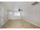 Bright and airy living room with tile flooring, ceiling fan, and large window at 6120 W Keim Dr, Glendale, AZ 85301