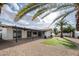 Backyard showcasing a covered patio, manicured lawn, gravel landscape and palm trees at 6130 E Windsor Ave, Scottsdale, AZ 85257