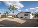 Spacious backyard featuring palm trees, gravel landscaping, and a well-maintained exterior at 6130 E Windsor Ave, Scottsdale, AZ 85257