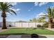 Backyard view featuring artificial turf, a white block wall, and desert landscaping at 6130 E Windsor Ave, Scottsdale, AZ 85257