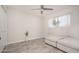 Neutral bedroom featuring a ceiling fan, tiled floor, window, and ottoman at 6130 E Windsor Ave, Scottsdale, AZ 85257