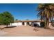 Charming single-story home with desert landscaping, mature trees, and arched entryway at 6130 E Windsor Ave, Scottsdale, AZ 85257