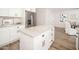 Bright kitchen featuring white cabinets, stainless appliances, a center island, and wood flooring at 6130 E Windsor Ave, Scottsdale, AZ 85257