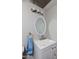 Compact and clean bathroom features updated vanity with oval mirror, toilet, and simple lighting at 711 E Mckinley St, Phoenix, AZ 85006