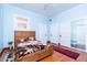 Bright bedroom with wooden floors, a floral comforter, and plenty of storage space at 711 E Mckinley St, Phoenix, AZ 85006