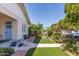 Manicured side yard with lush greenery, artificial turf, and charming landscaping at 711 E Mckinley St, Phoenix, AZ 85006