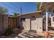 Outbuilding in backyard with neutral colors, standard door, and a window at 711 E Mckinley St, Phoenix, AZ 85006
