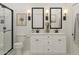 Clean bathroom features a double vanity, modern lighting, framed mirrors, and a glass-enclosed shower at 7646 W Park St, Laveen, AZ 85339